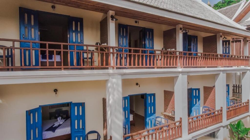 a building with blue doors and balconies at Zen Boutique House in Luang Prabang