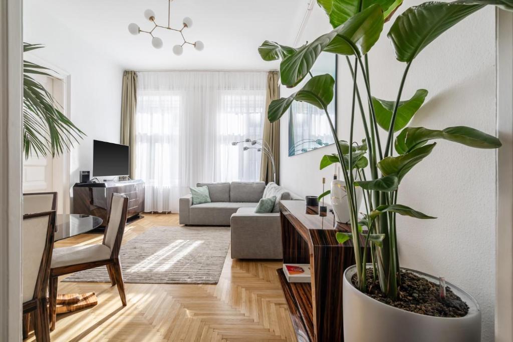 a living room with a large potted plant at Aviator luxury apartment in the city center in Budapest