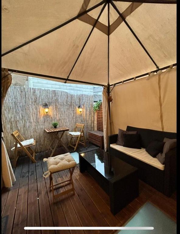 a living room with a couch and an umbrella at Trier City Center Apartments Altstadt in Trier