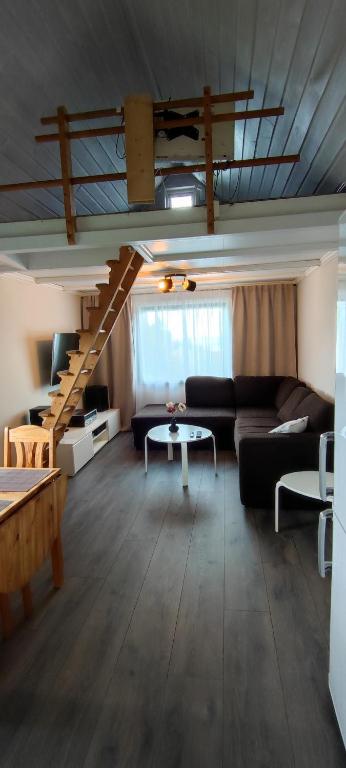 a living room with a couch and a staircase at Lille huset in Holmestrand
