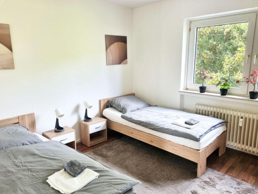 1 dormitorio con 2 camas y ventana en Apartment with Balcony, en Kronberg im Taunus