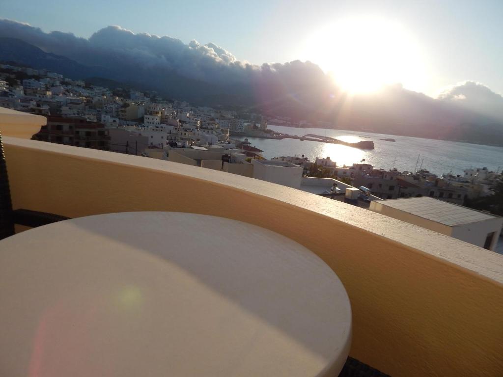 a white toilet on a balcony with a view of a city at Epiphany Apartments in Karpathos Town