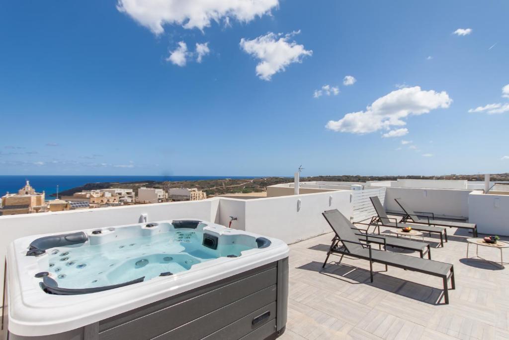 沙拉的住宿－Seaview And Wellness Penthouse In Gozo - Happy Rentals，房屋屋顶上的热水浴池