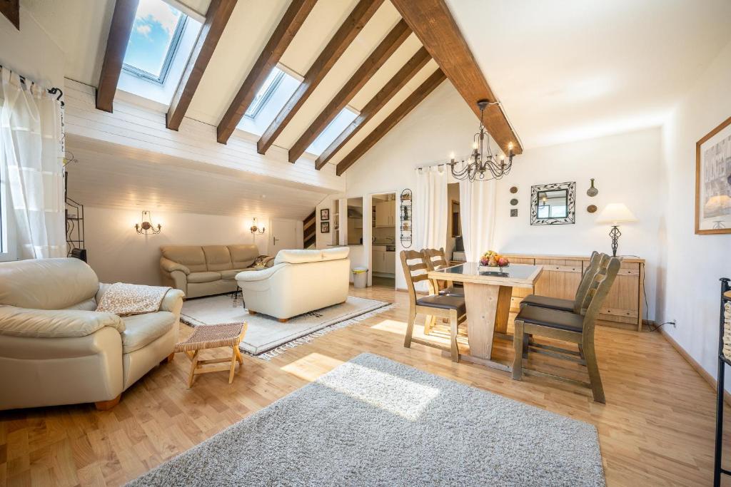 a living room with a couch and a table at 5401 Grosszuegige Dachgeschoss-Wohnung mit Parkettboden und Balkon - Moderne und helle Gestaltung in Vulpera