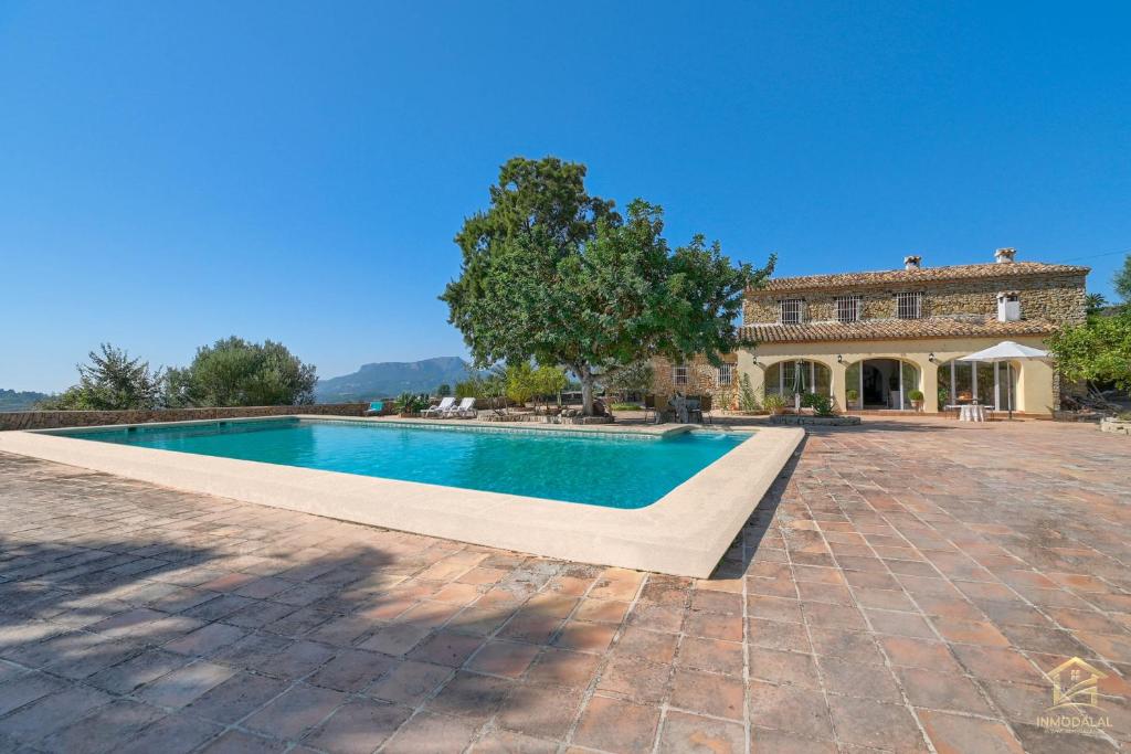 a swimming pool in front of a house at Villa Katerina in Benissa