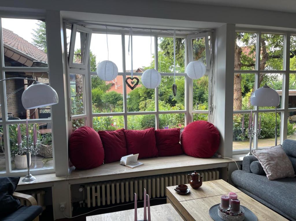 a living room with a red couch in front of a window at Ferienwohnung im Obstgarten in Bad Pyrmont