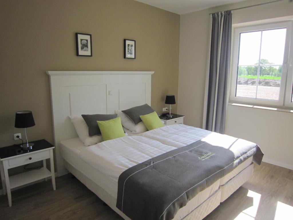 a bedroom with a large bed and a window at Landhotel zum grünen Kranze in Espelkamp-Mittwald