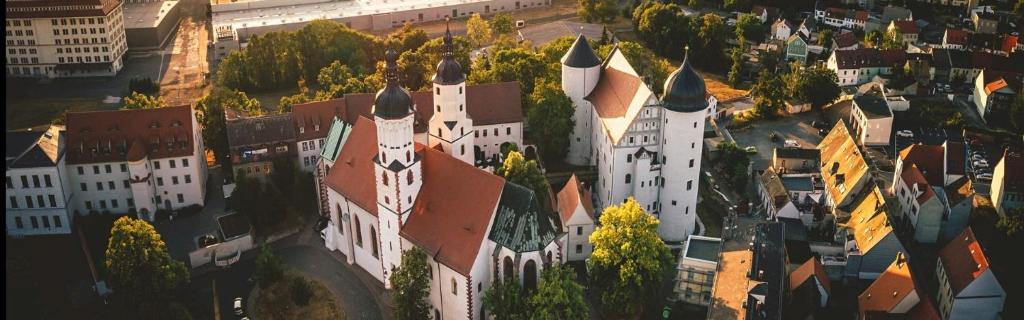 an aerial view of a large building with turrets at Schloss Hotel Wurzen in Wurzen