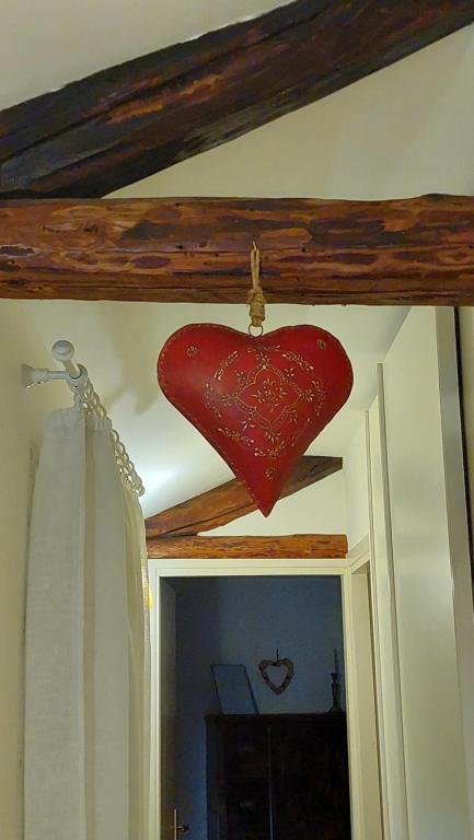 a red heart hanging from the ceiling of a bathroom at Il Vicoletto in Vittorio Veneto