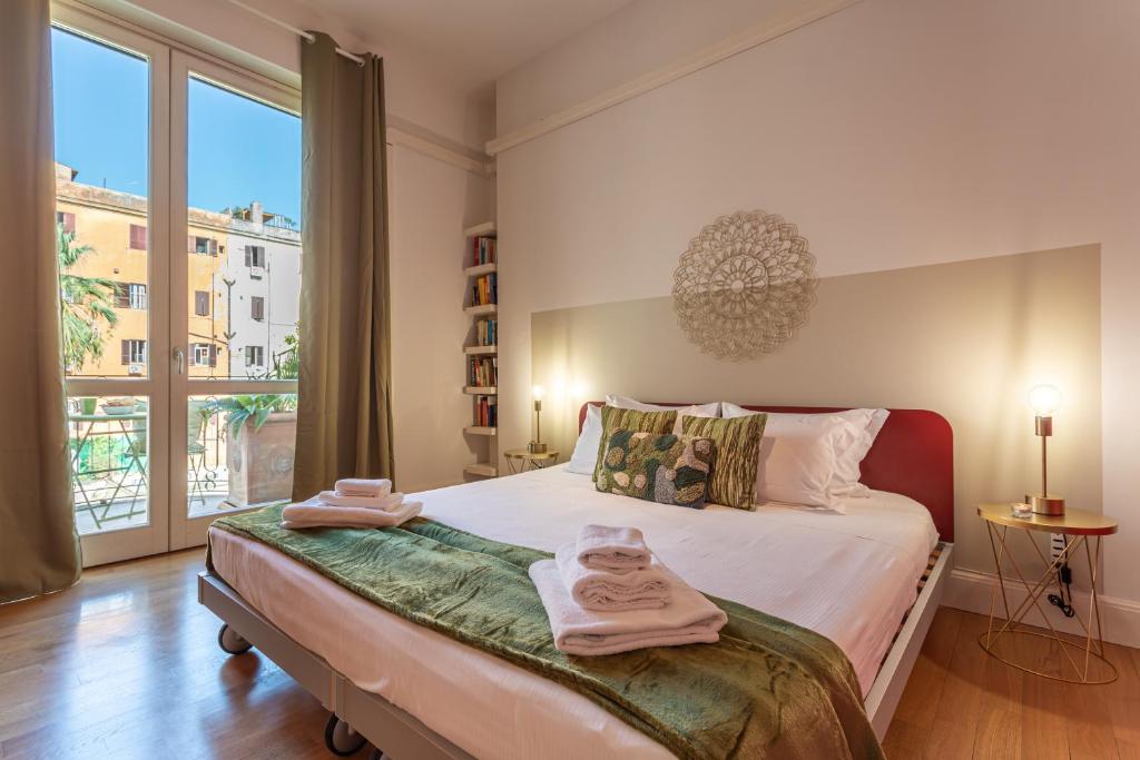 a bedroom with a bed with towels on it at Oasis Rome Centre Apartment in Rome