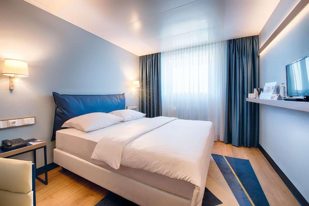 Postel nebo postele na pokoji v ubytování Congress Hotel Chemnitz