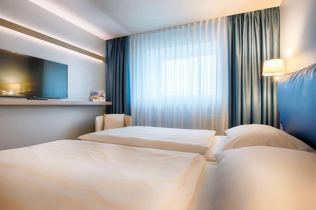 Postel nebo postele na pokoji v ubytování Congress Hotel Chemnitz