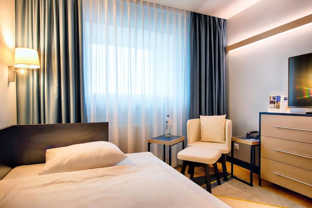Postel nebo postele na pokoji v ubytování Congress Hotel Chemnitz
