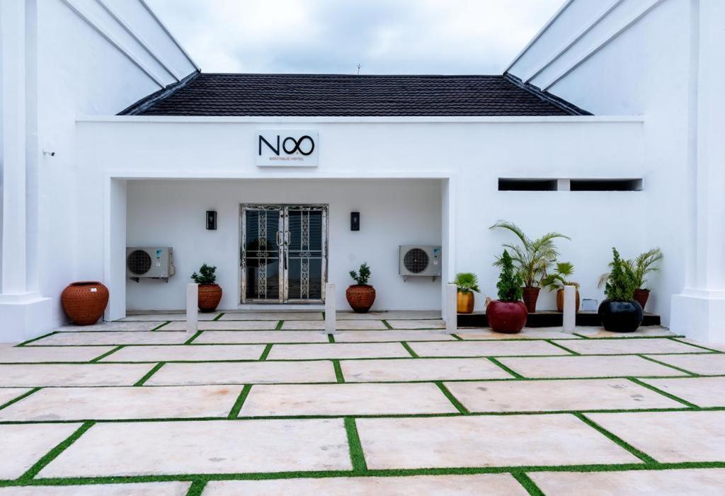 a white building with a noo sign on it at No.8 Boutique Hotel in Ilorin