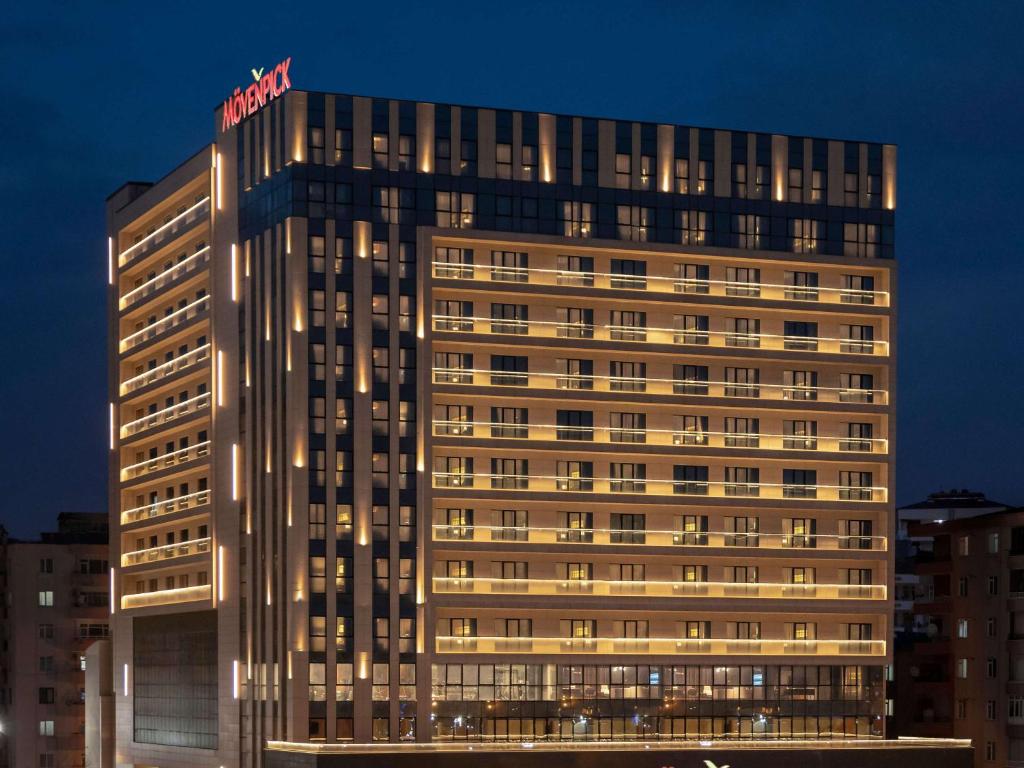 a tall building with a hotel sign on top of it at Movenpick Diyarbakir in Diyarbakır