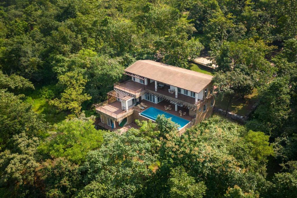 an overhead view of a house in the woods at Eden Glade - Khopoli - Mountain-view villa with Private pool, Spacious decks & Indoor activities in Khopoli