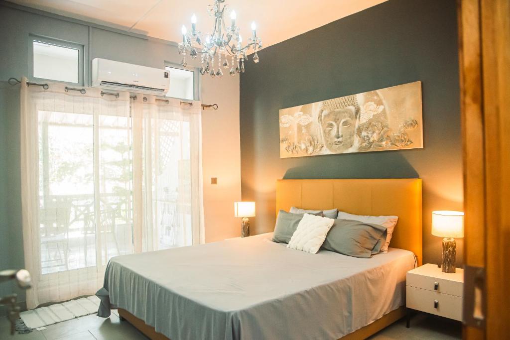 a bedroom with a bed and a chandelier at Gorgeous KEJ in Pereybere 2 Bed Apartment in Pereybere