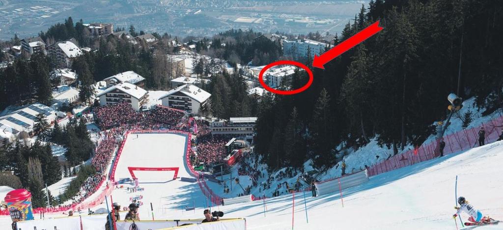 a red arrow is pointing at a ski slope at Appartement proche remontées refait à neuf in Crans-Montana