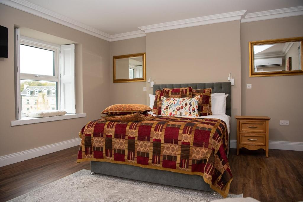 a bedroom with a bed and a window at Donegal House in Donegal