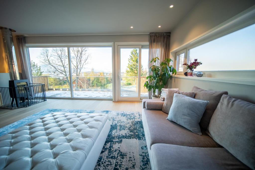 a living room with a couch and a large window at Tromsø Town House in Tromsø