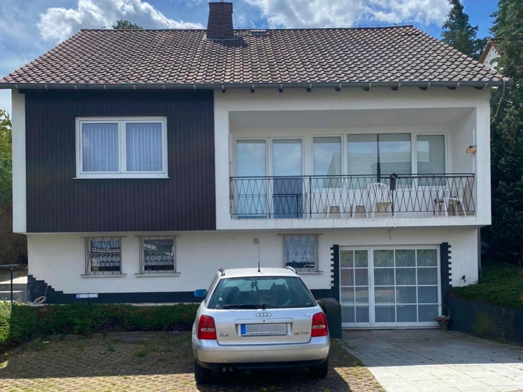 a car parked in front of a house with a balcony at Apartments with Garden in Bad Vilbel