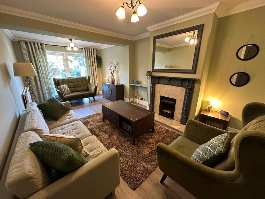 a living room with two couches and a fireplace at Stylish & Homely 3 BR House in Sale
