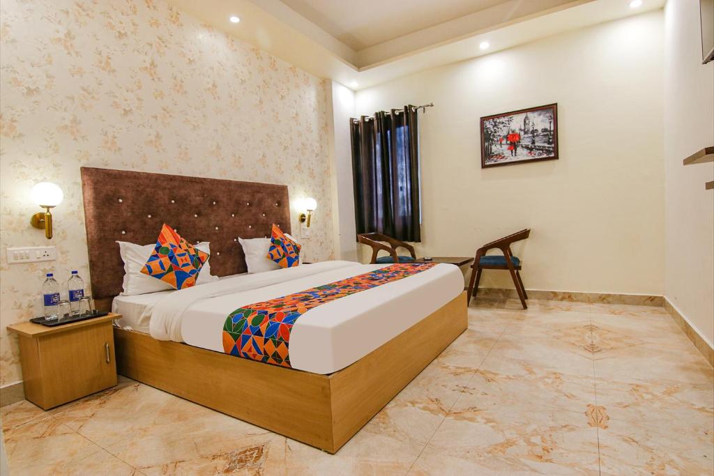 a bedroom with a large bed in a room at FabHotel Crown Star in Dehradun