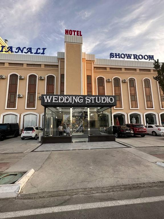 a building with a wedding studio in a parking lot at LIANALI Plaza in Bukhara