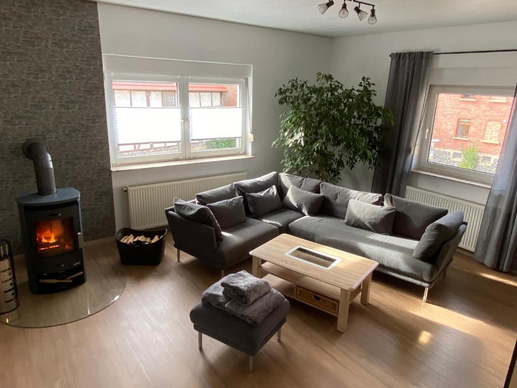 a living room with a couch and a wood stove at Ferienwohnung Riese Nordhessen in Felsberg