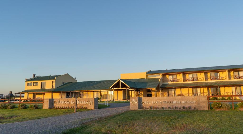 um grande edifício com uma placa em frente em Un Alto en la Huella - Hotel Spa & Wellness Resort em San Antonio de Areco