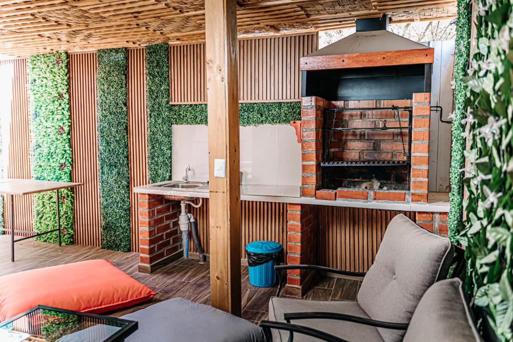a living room with a fireplace and a couch at 2 Cabañas para 5 Personas Oasis Pica-Matilla in Pica