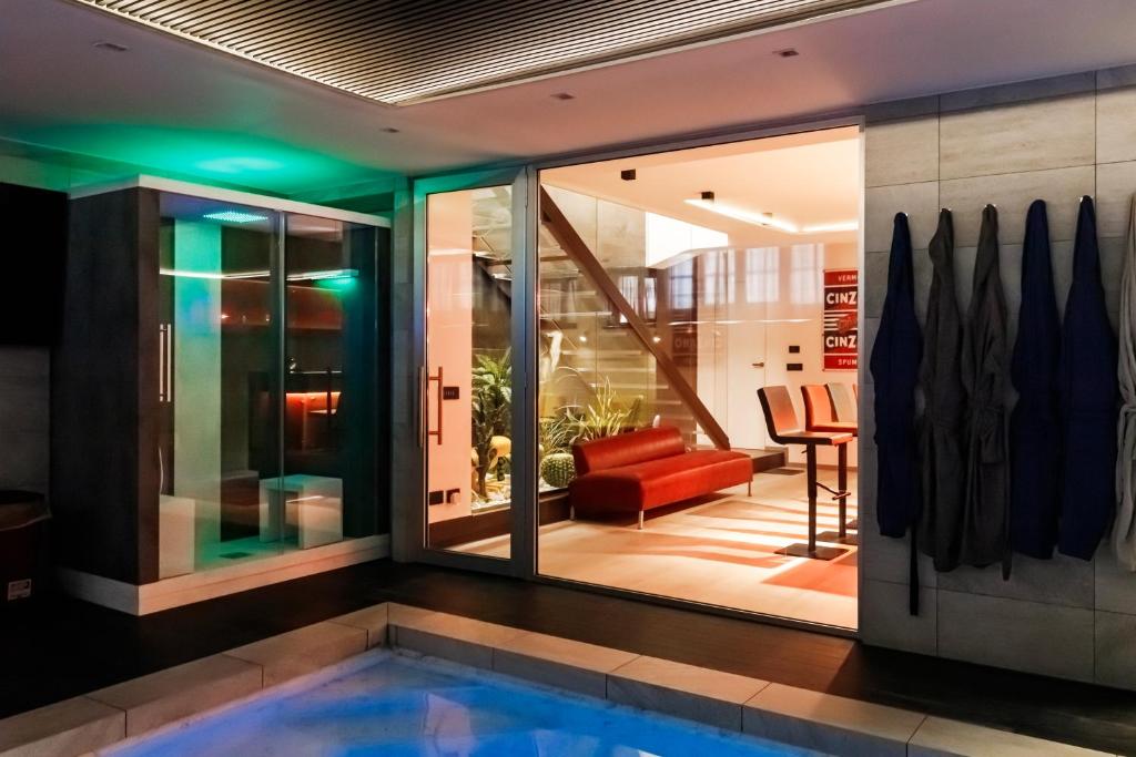a house with a swimming pool and a living room at N18 luxury boutique apartment with a private pool & spa in Milan