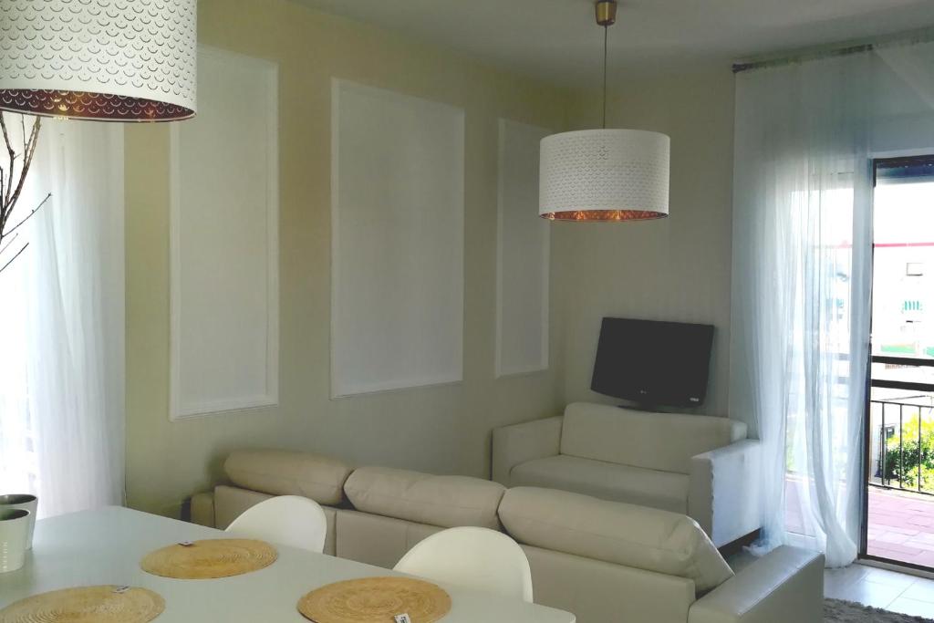 ein Wohnzimmer mit einem Sofa und einem TV in der Unterkunft La casa de Leon XIII.Terraza Privada. Parejas in Sevilla