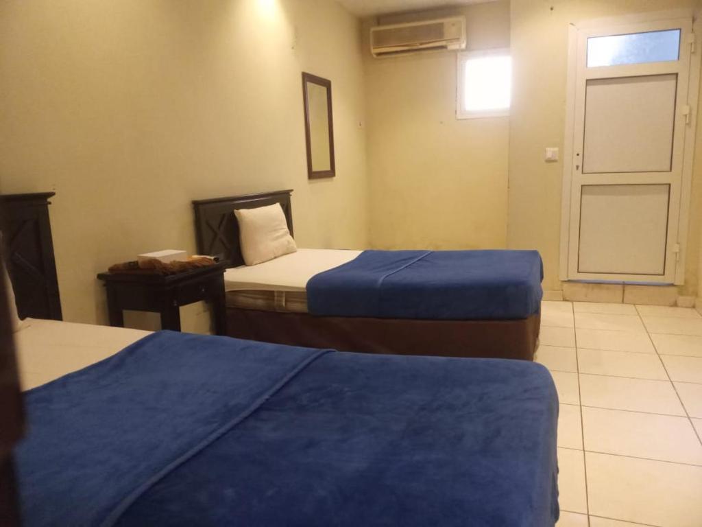 a hotel room with two beds and a window at سلسبيل للغرف المفروشة in Al Khobar