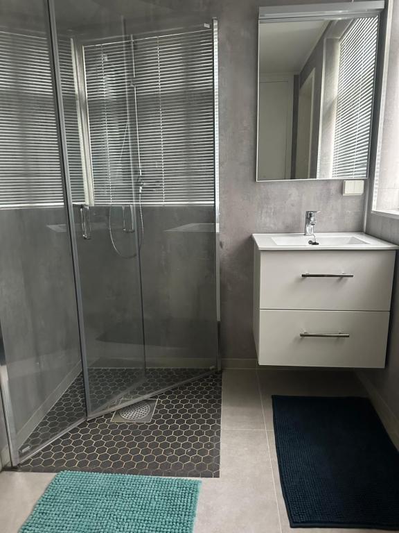 a bathroom with a shower and a sink at Downtown Historical House with Renovated apartments in Ålesund