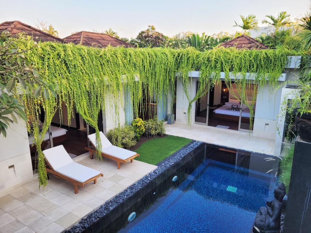 an external view of a villa with a swimming pool at Bali - Jimbaran Bay 2 Bedroom Villa in Jimbaran