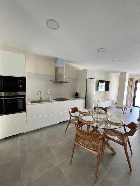 a kitchen with a table and chairs in a room at Arena Coral - Main Street - 50m Beach in Corralejo