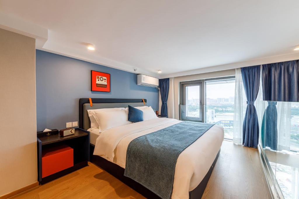 Postel nebo postele na pokoji v ubytování Livetour Hotel Sanxi Metro Guangzhou