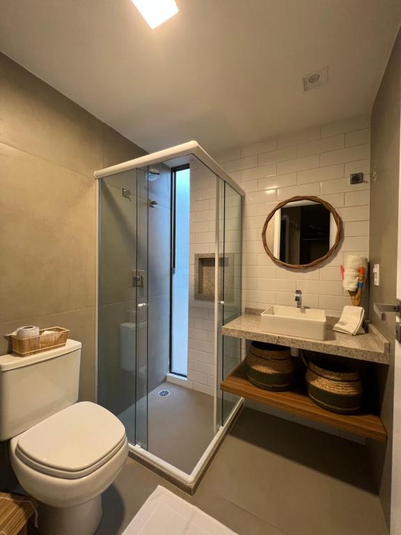 a bathroom with a shower and a toilet and a sink at Casa Nina Milagres in São Miguel dos Milagres