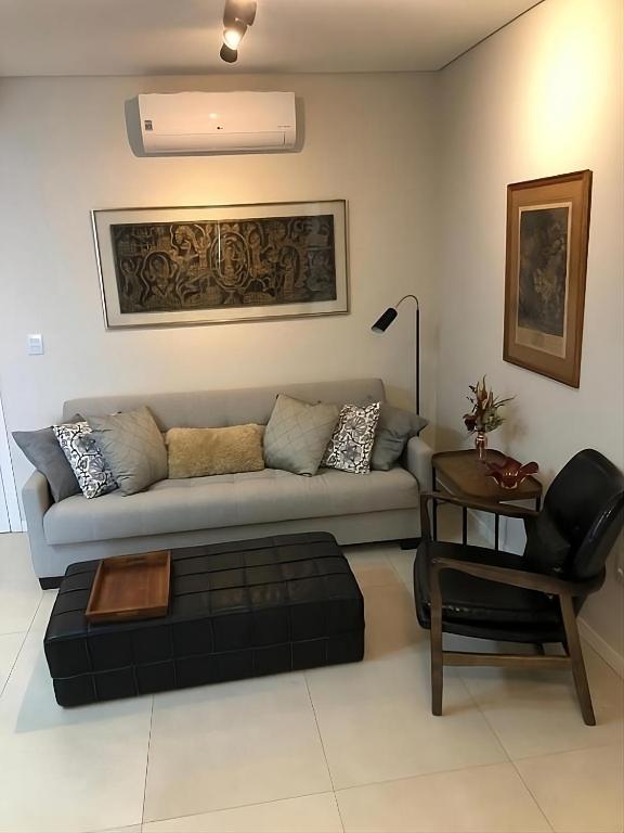 a living room with a couch and a chair at Requinte e Conforto OP - MG in Ouro Preto