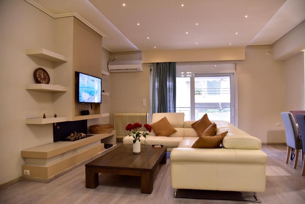 a living room with a couch and a table at Gtrip Piraeus Floor Apartment - 8324 in Piraeus