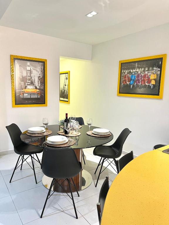 a dining room with chairs and a table with glasses at Modern Central 2BR Flat in Valletta by Arco Collection in Valletta