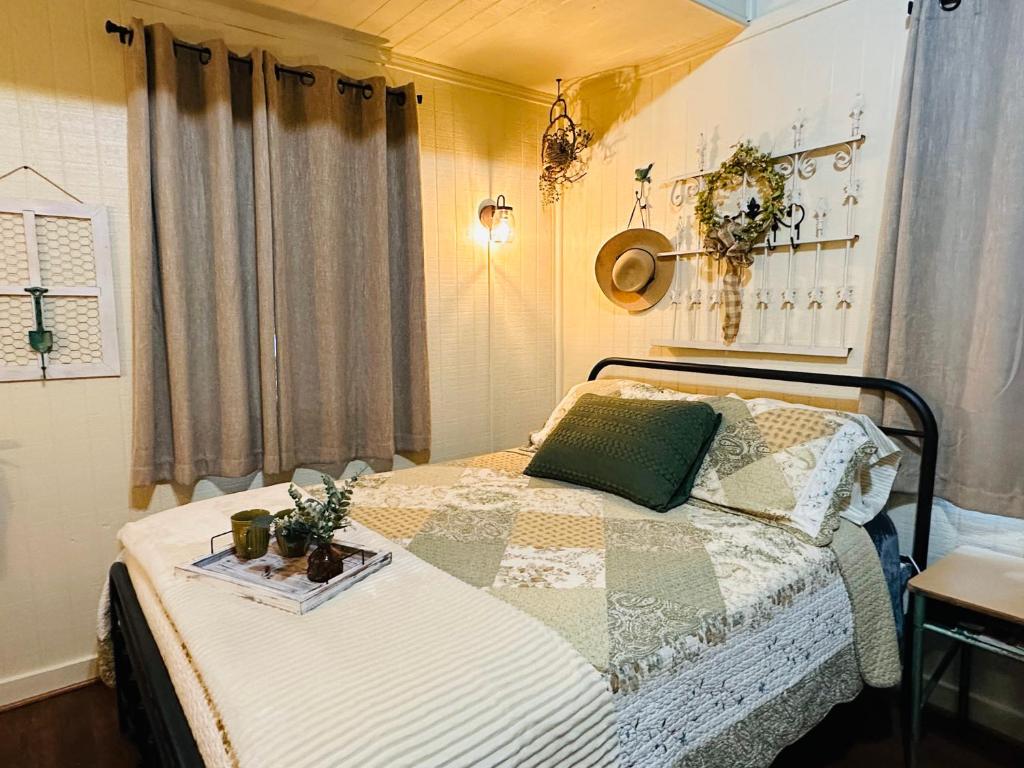a bedroom with a bed with a tray on it at Acorn Hideaways Canton Unwind at Green Gables Suite for up to 3 in Canton