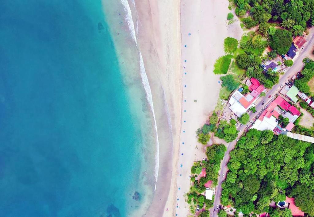 an overhead view of a beach and the ocean at Surf Ranch Tamarindo in Tamarindo