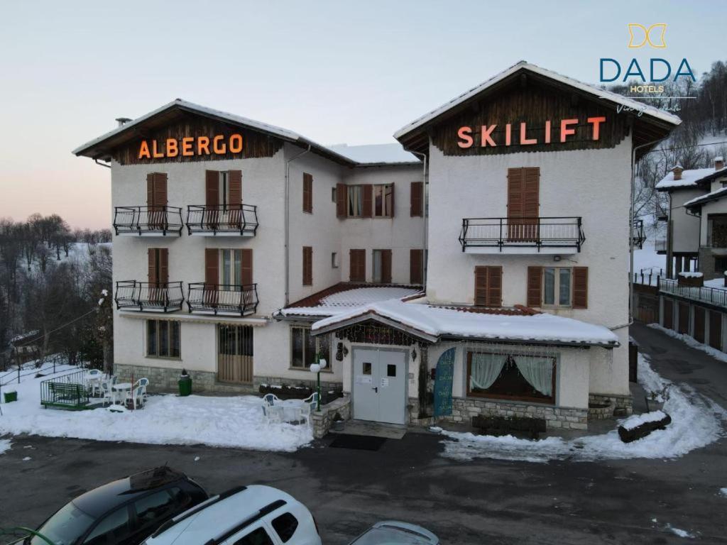 a large white building with a ski lift at Hotel Skilift - Dada Hotels in Frabosa Soprana