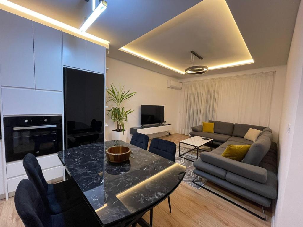 a living room with a table and a couch at Royal Seaview Apartment in Durrës