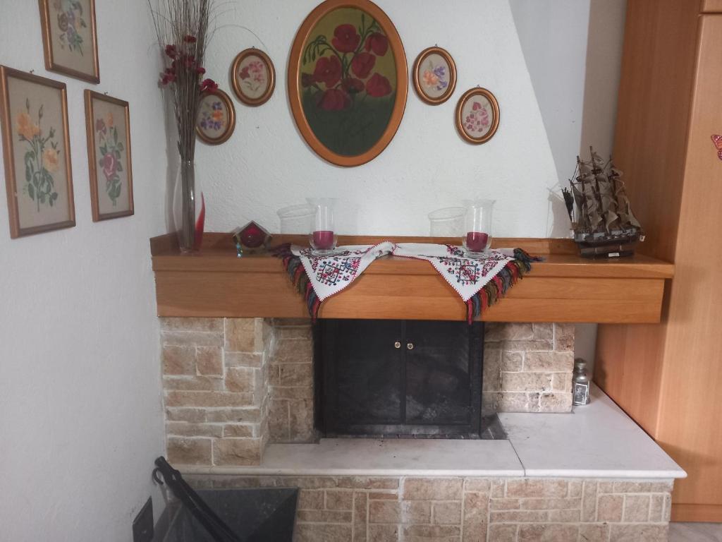 a fireplace with a mantle with candles on it at Στουντιο με πάρκινγκ κοντά στην κλινική Αγ Λουκας in Thessaloniki