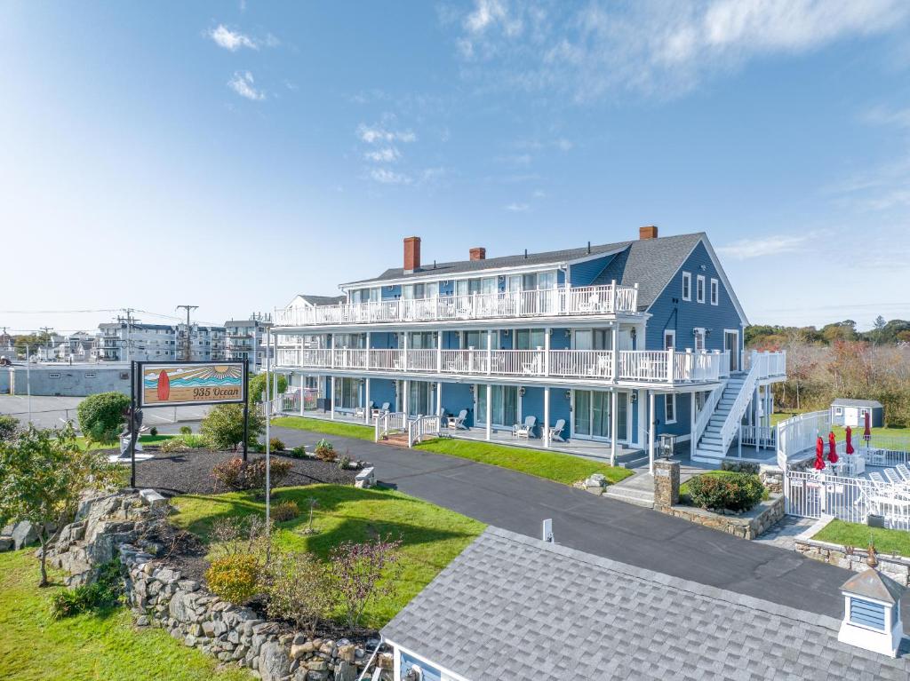 a large blue and white building with a walkway at 935 Ocean, a Beachside Inn in Hampton