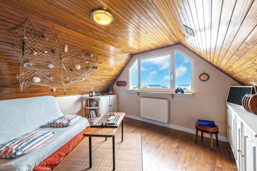 a living room with a couch and a window at Meublé De Tourisme Acanthe in Camaret-sur-Mer