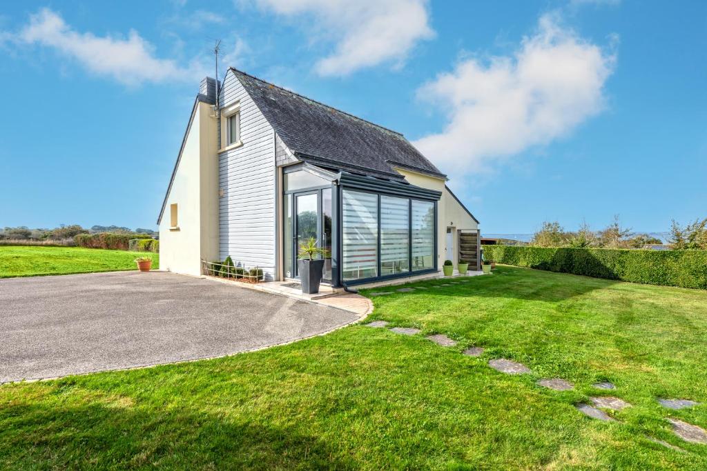 a church with a driveway and grass at Meublé De Tourisme Acanthe in Camaret-sur-Mer